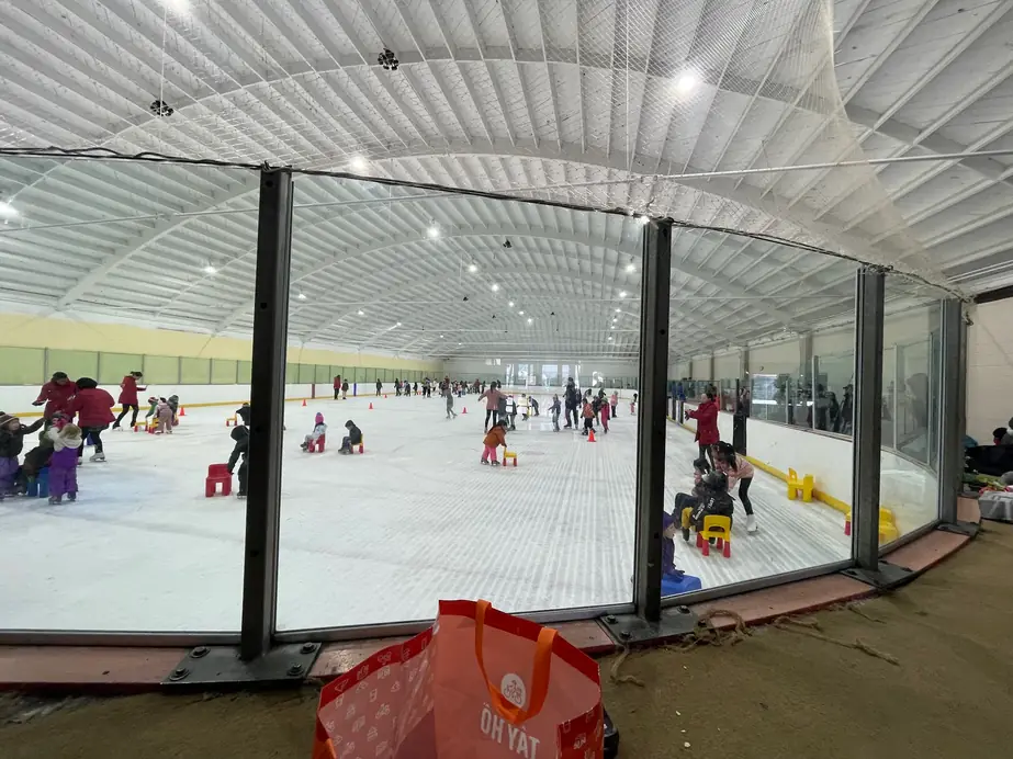 A Learn to Skate class on the Ontario ice, practice chairs out and coaches in red