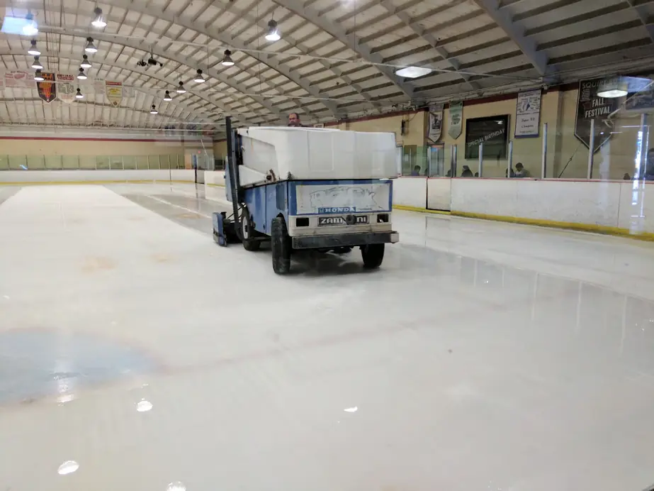 The blue resurfacer crossing the Ontario rink under the hanging championship banners